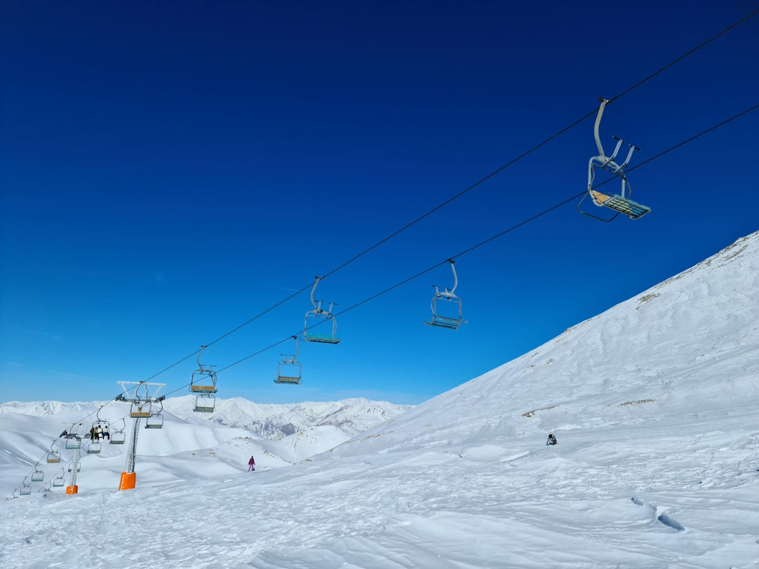 a ski lift going up a snowy mountain