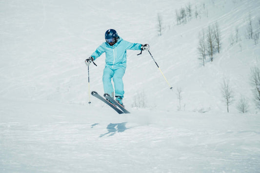 a person riding skis down a snow covered slope
