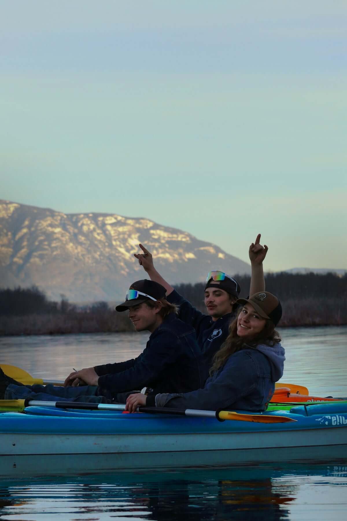 a group of people riding on the back of a kayak