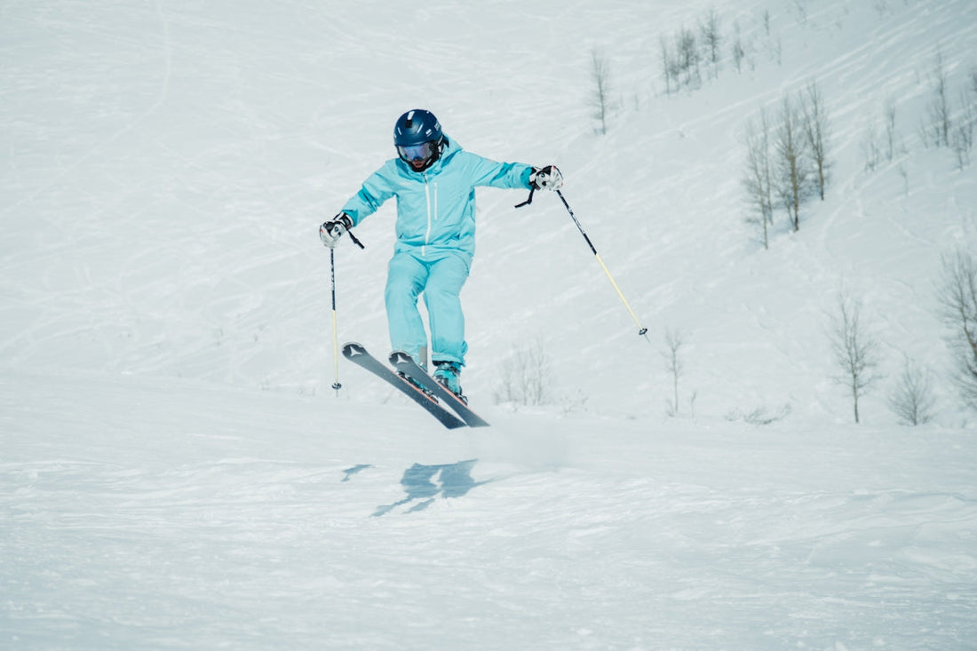 a person riding skis down a snow covered slope