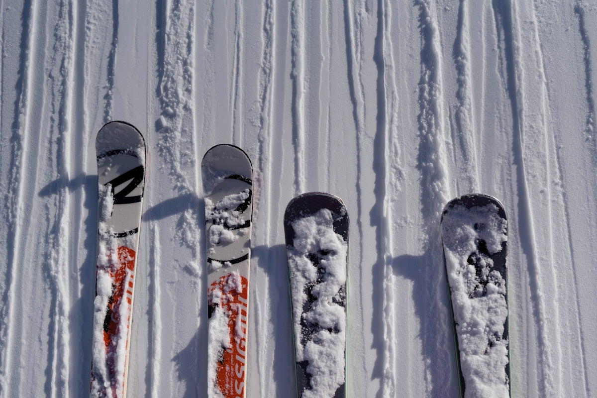 three skis and a pair of ski poles in the snow