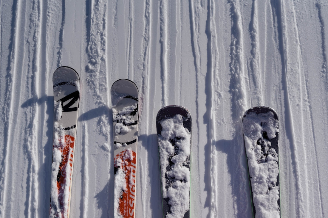three skis and a pair of ski poles in the snow