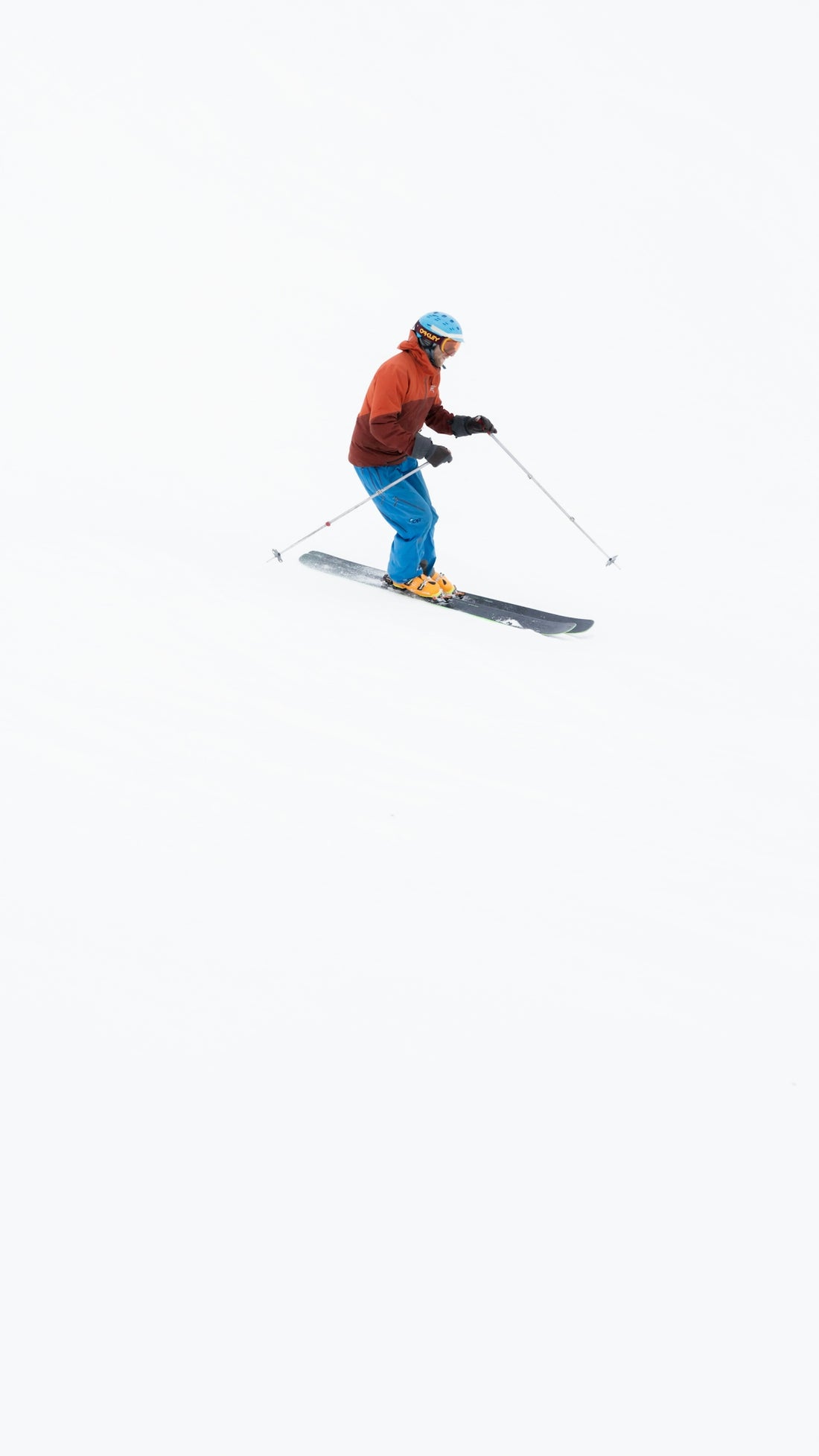 a man riding skis down a snow covered slope