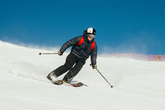 A man riding skis down a snow covered slope