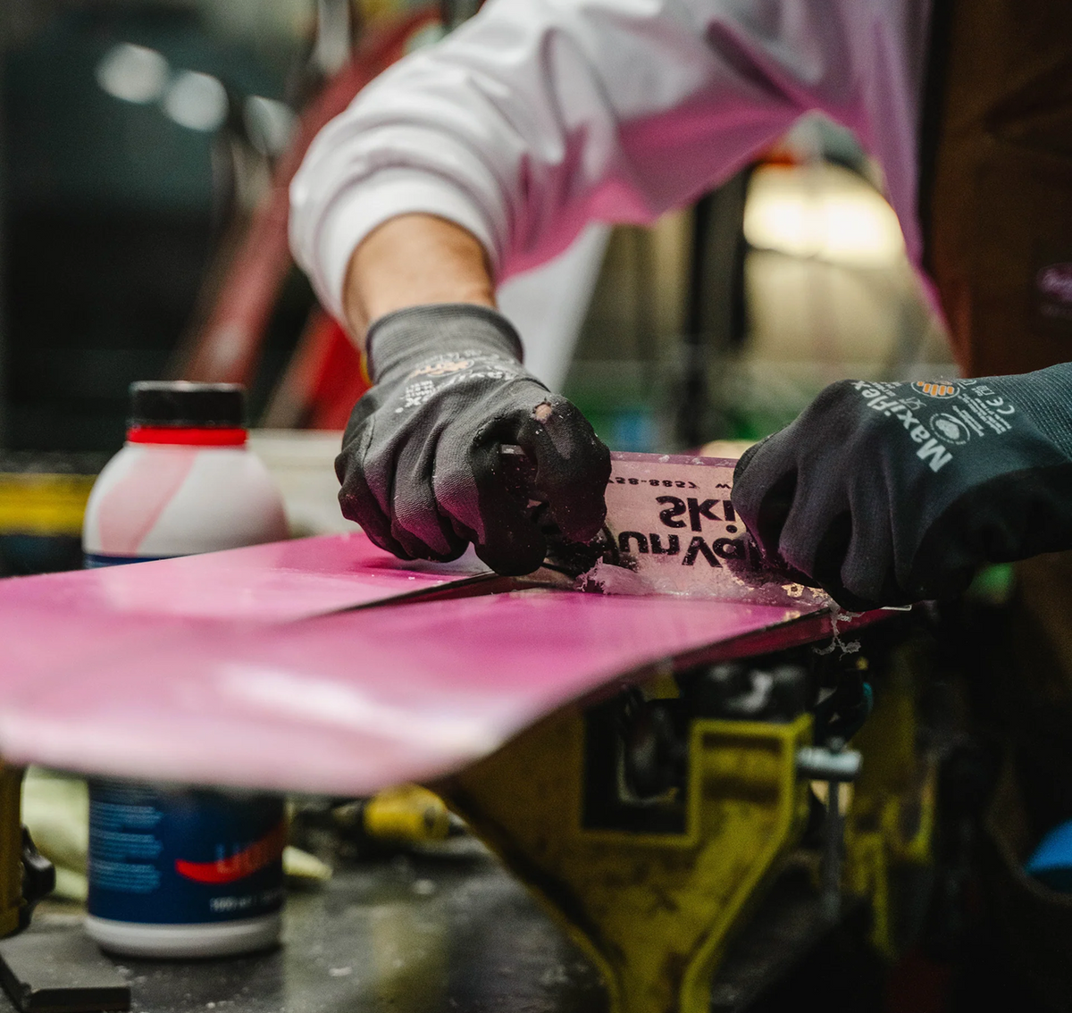 Scraping a ski base on the tuning bench at Alpine Base & Edge