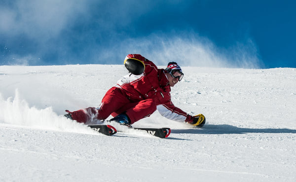 Expert skier carving in powder snow